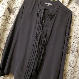 100% silk shirt with ruffled along the front.